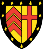 Clare College heraldic shield: The Clare coat of arms is divided into two equal parts. On the left hand side there are the three chevrons of the de Clare family. On the other side of the shield is the Cross, the symbol of the Christian roots of the College.