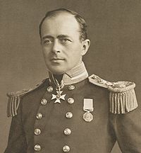 Man with receding hairline, looking left, wearing naval uniform with medals, polished buttons and large epaulettes