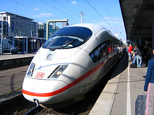 Sleek white passenger train at a station