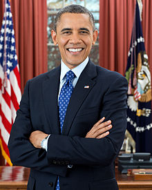 U.S. President Barack Obama is photographed standing in front of the Resolute Desk in the Oval Office of the White House, December 6, 2012.